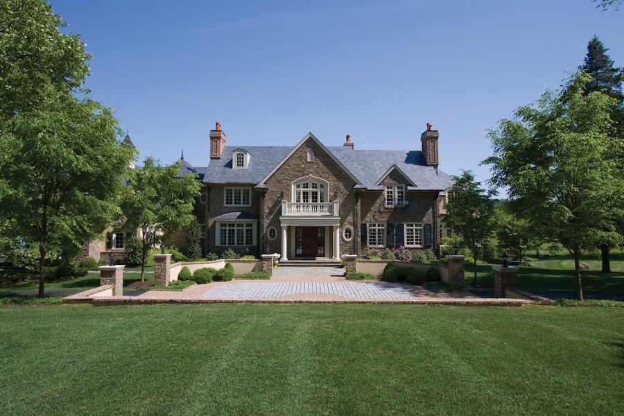 Stone manor house set back on a wide lawn in Bucks County