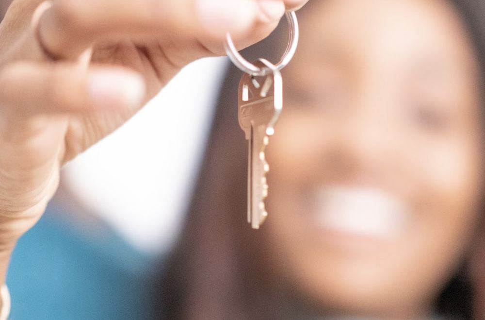 A new homeowner holding up the keys to their house