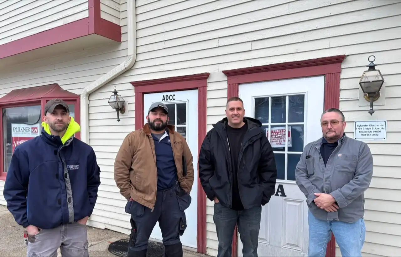Sylvester Electric team outside a building