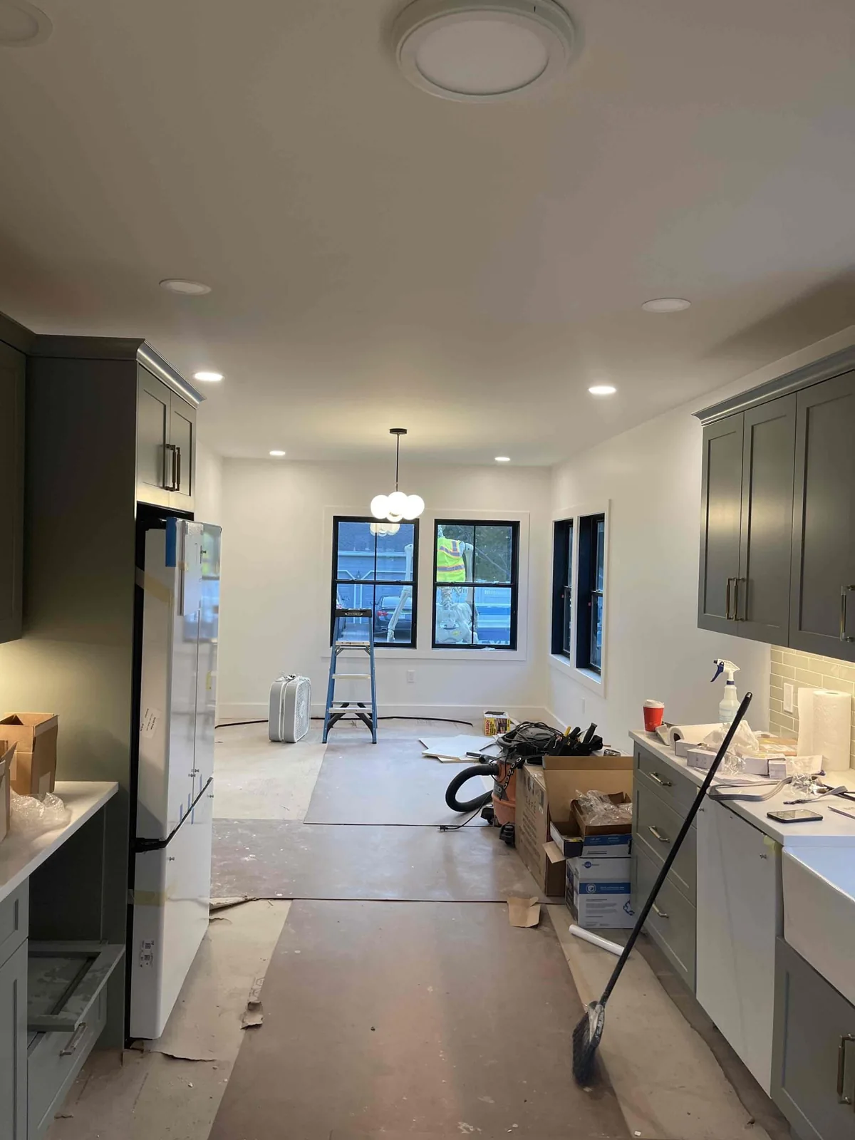 Kitchen ceiling lighting and cabinets during the finish stage