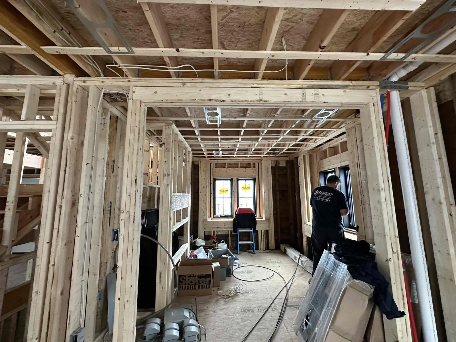 Framed rooms with wiring visible during construction