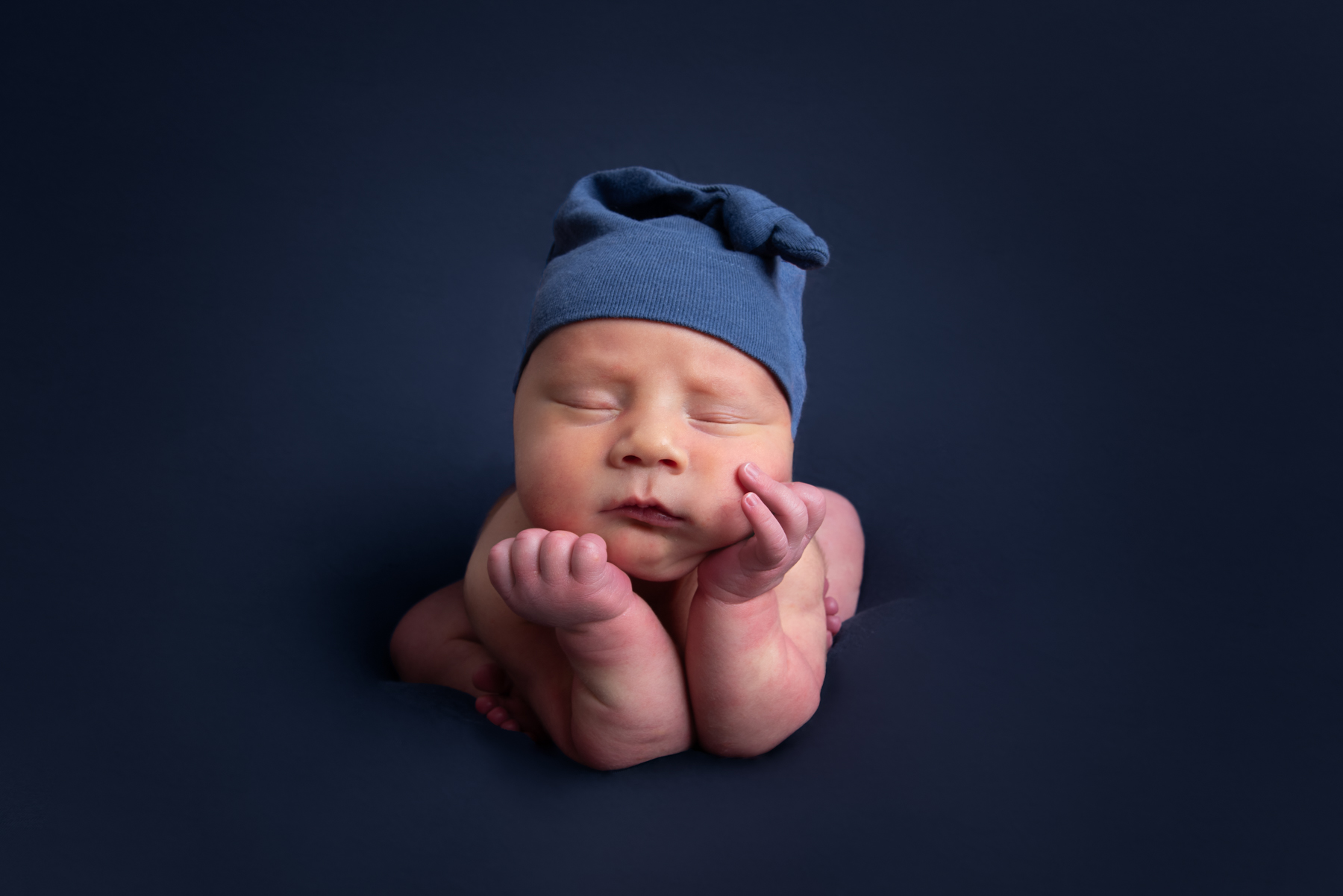 Newborn baby boy in froggy pose composite