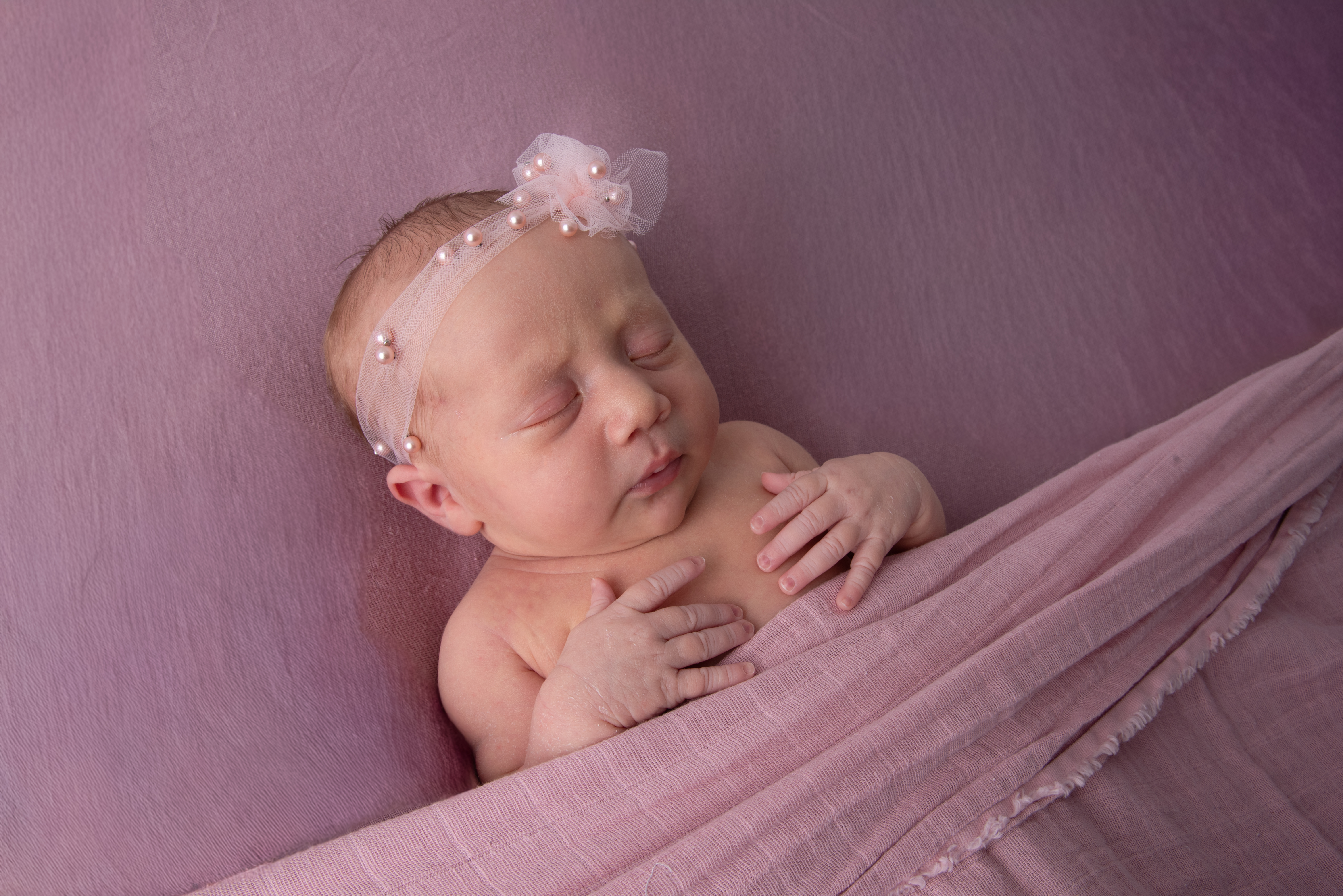 newborn girl in mauve set at Flamingo and Palm Studio