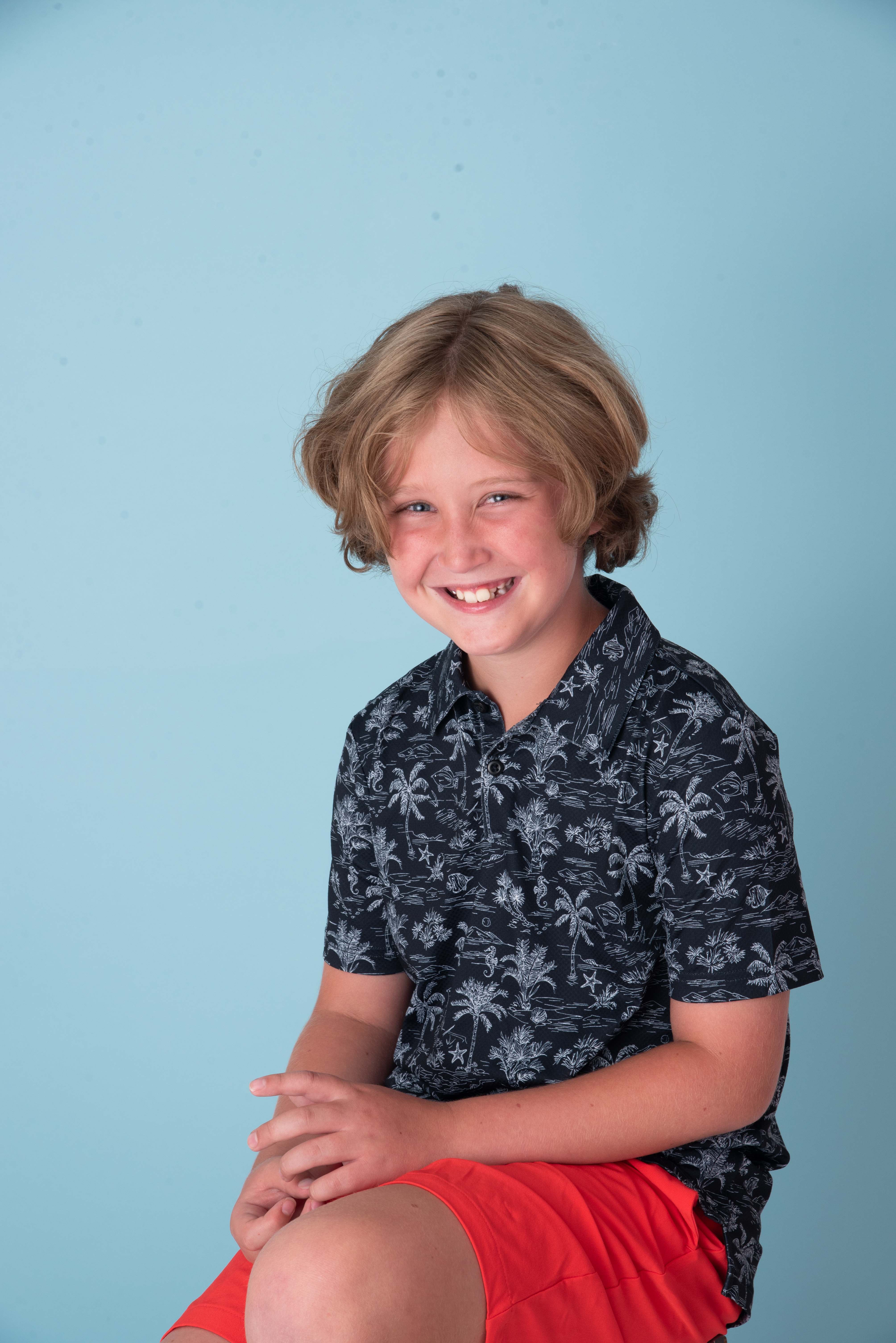 10 year old boy smiling at the camera in boise studio Flamingo and Palm