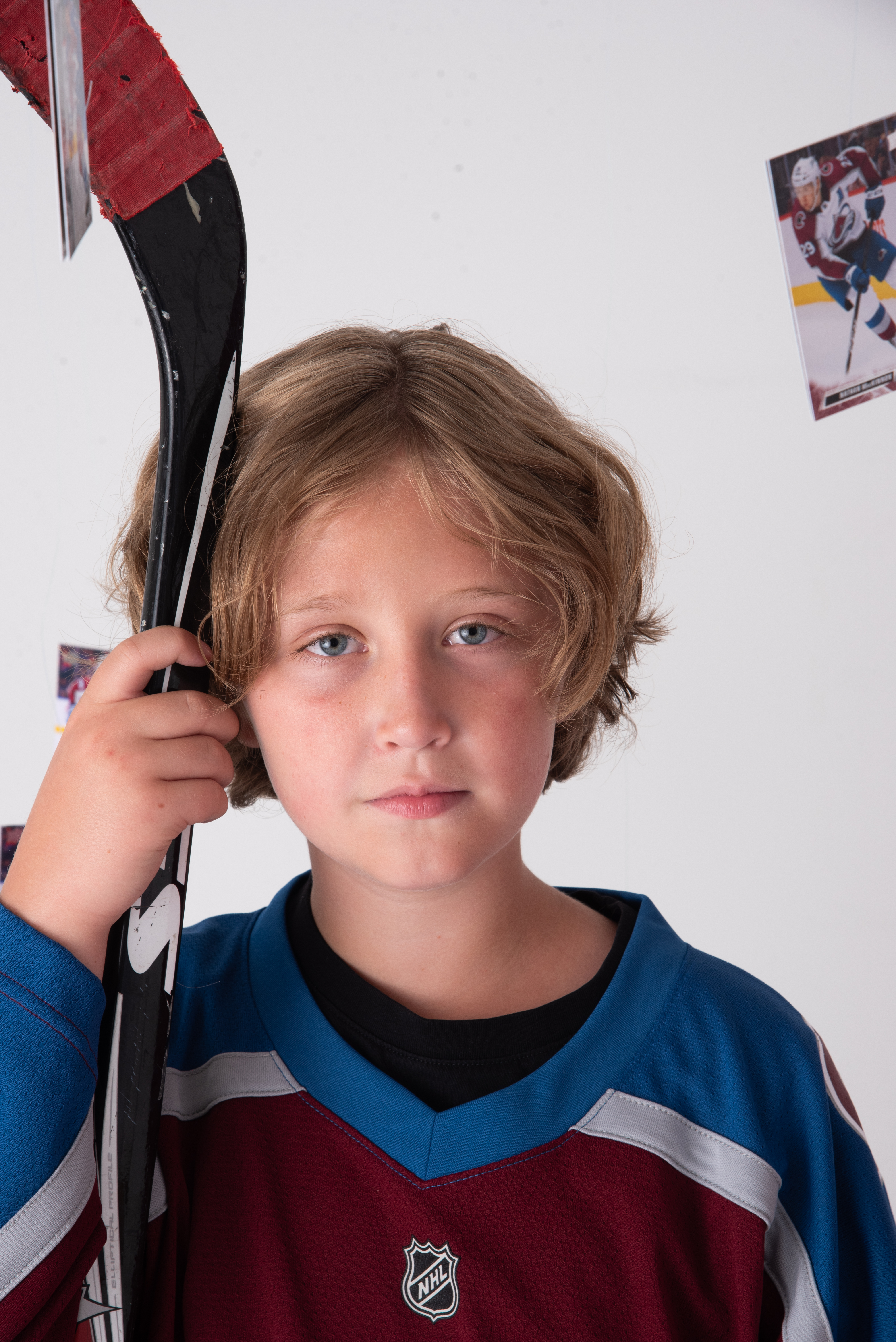 Hockey photograph with 10 year old leaning on his stick