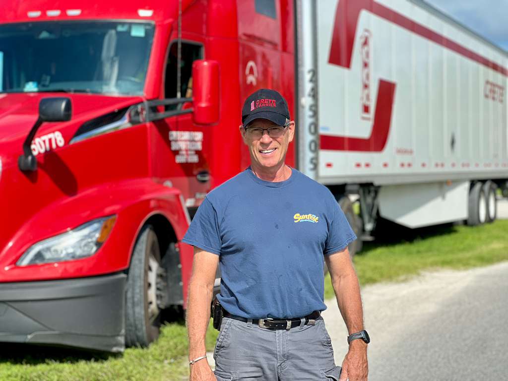 Kevin standing by red truck