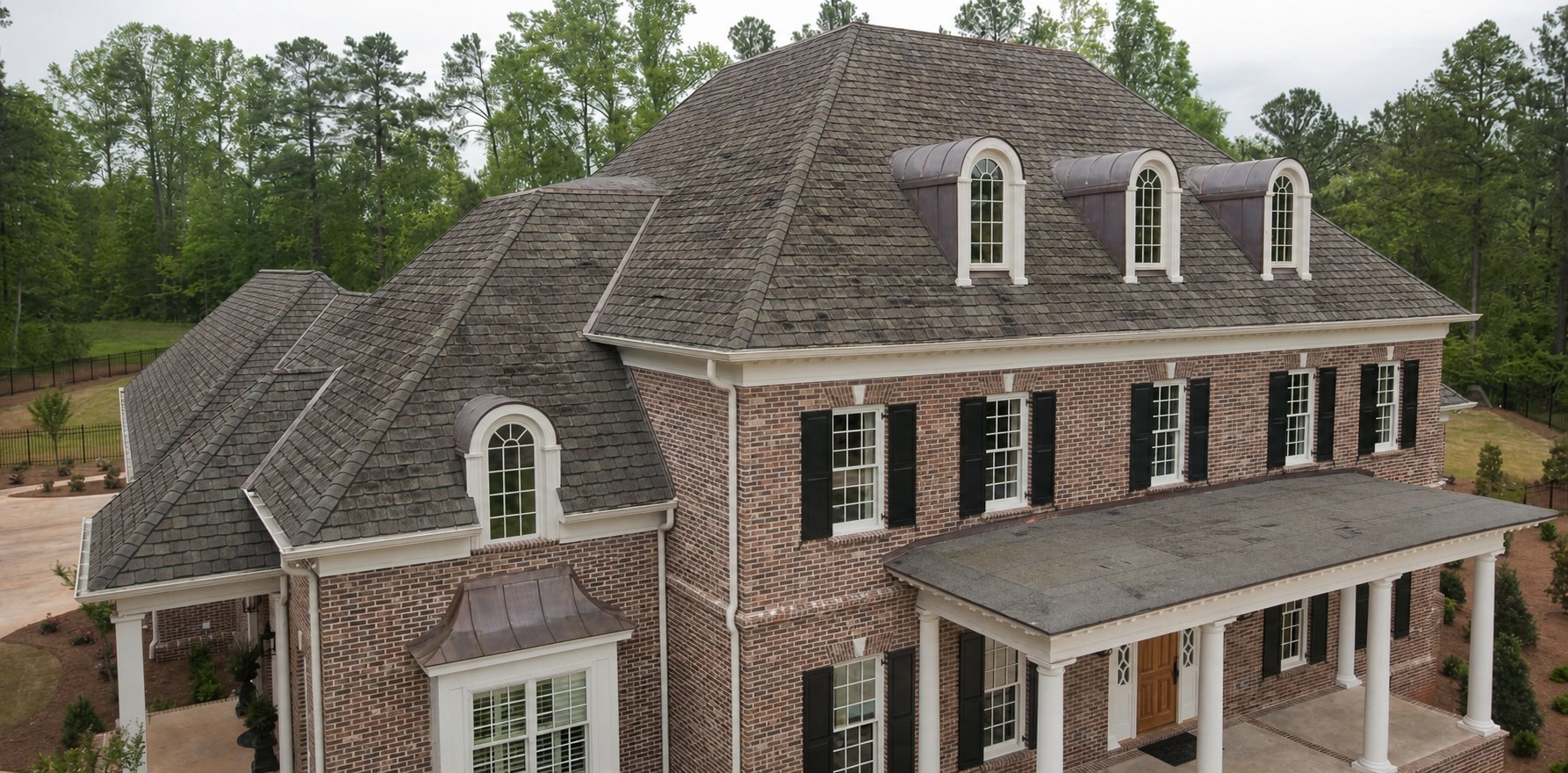 Residential roof before replacement with aged and weathered shingles