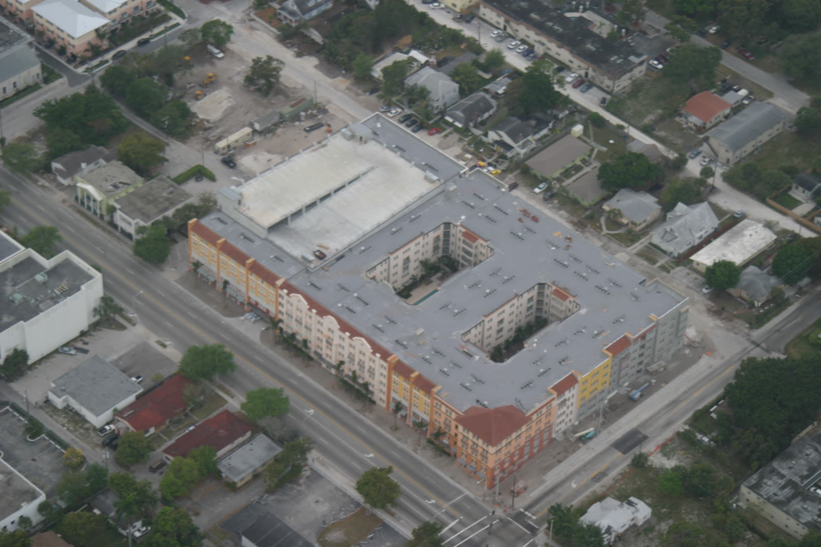 Mid-rise urban residential building with a large flat, low-slope roof