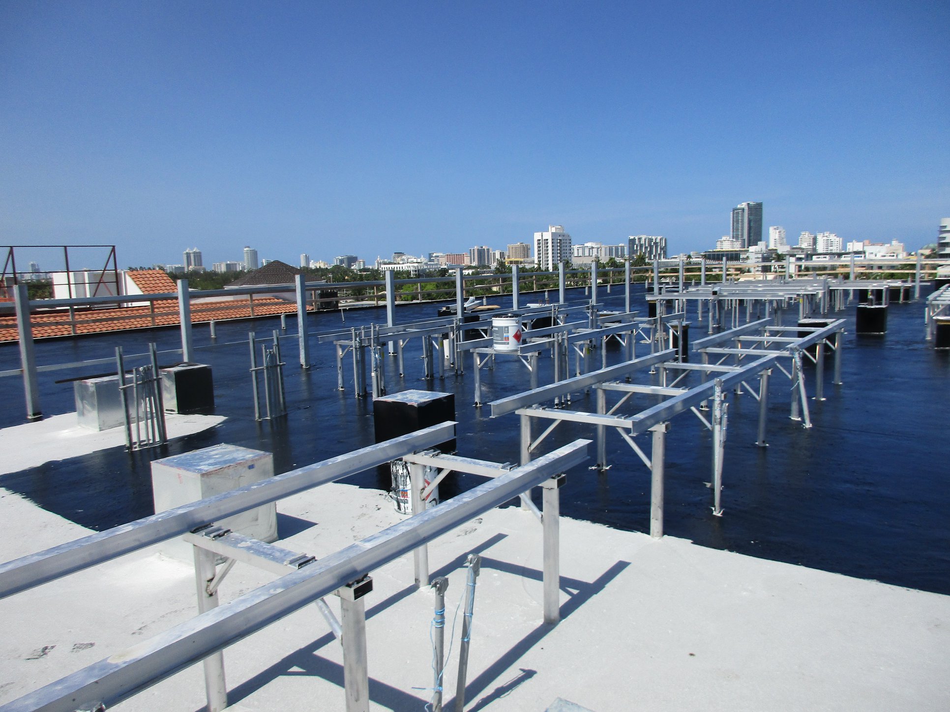 Elevated flat roof deck with new steel framing and the city skyline beyond