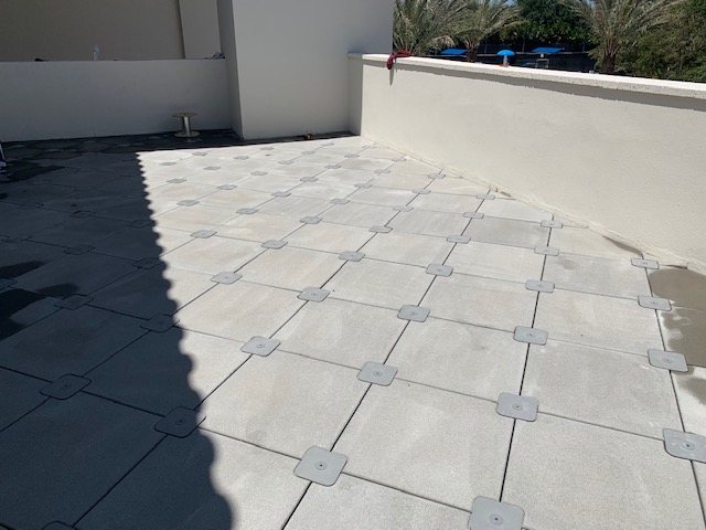 Rooftop deck finished with pedestal-set pavers over a waterproofed surface