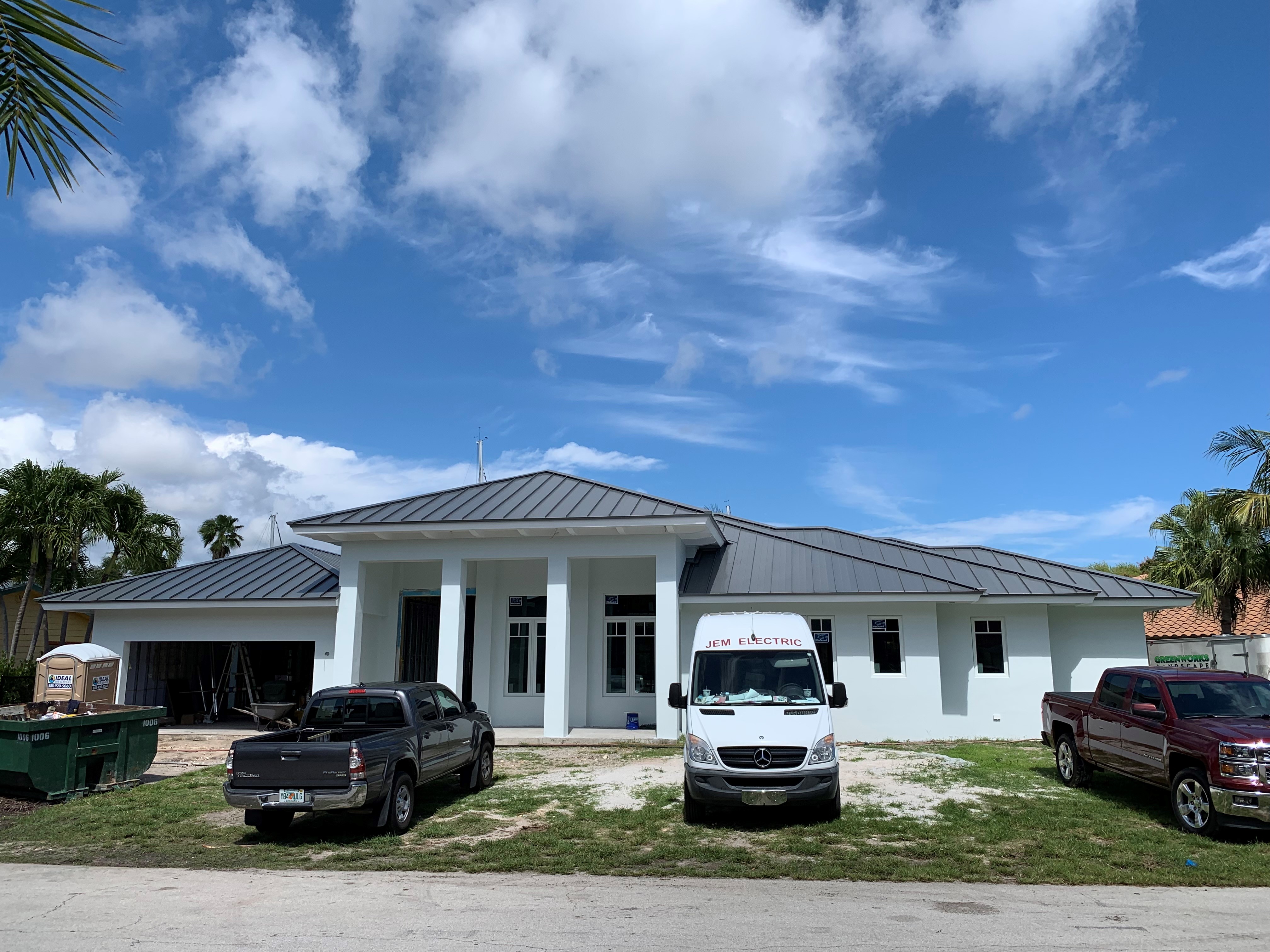Completed dark standing seam metal roof on a South Florida home