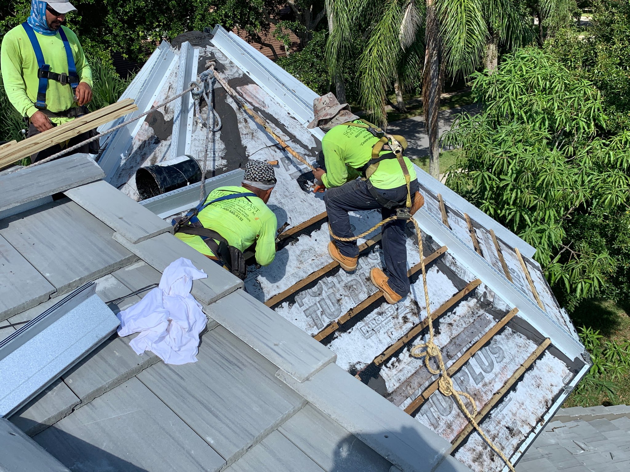 Southern Coast Enterprises roofing crew installing tile roofing on a residential roof