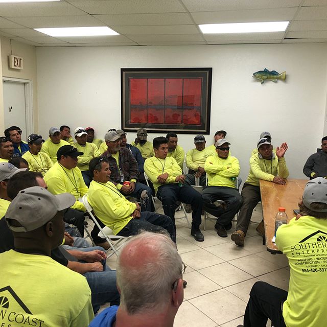 Southern Coast crew members gathered in a meeting room
