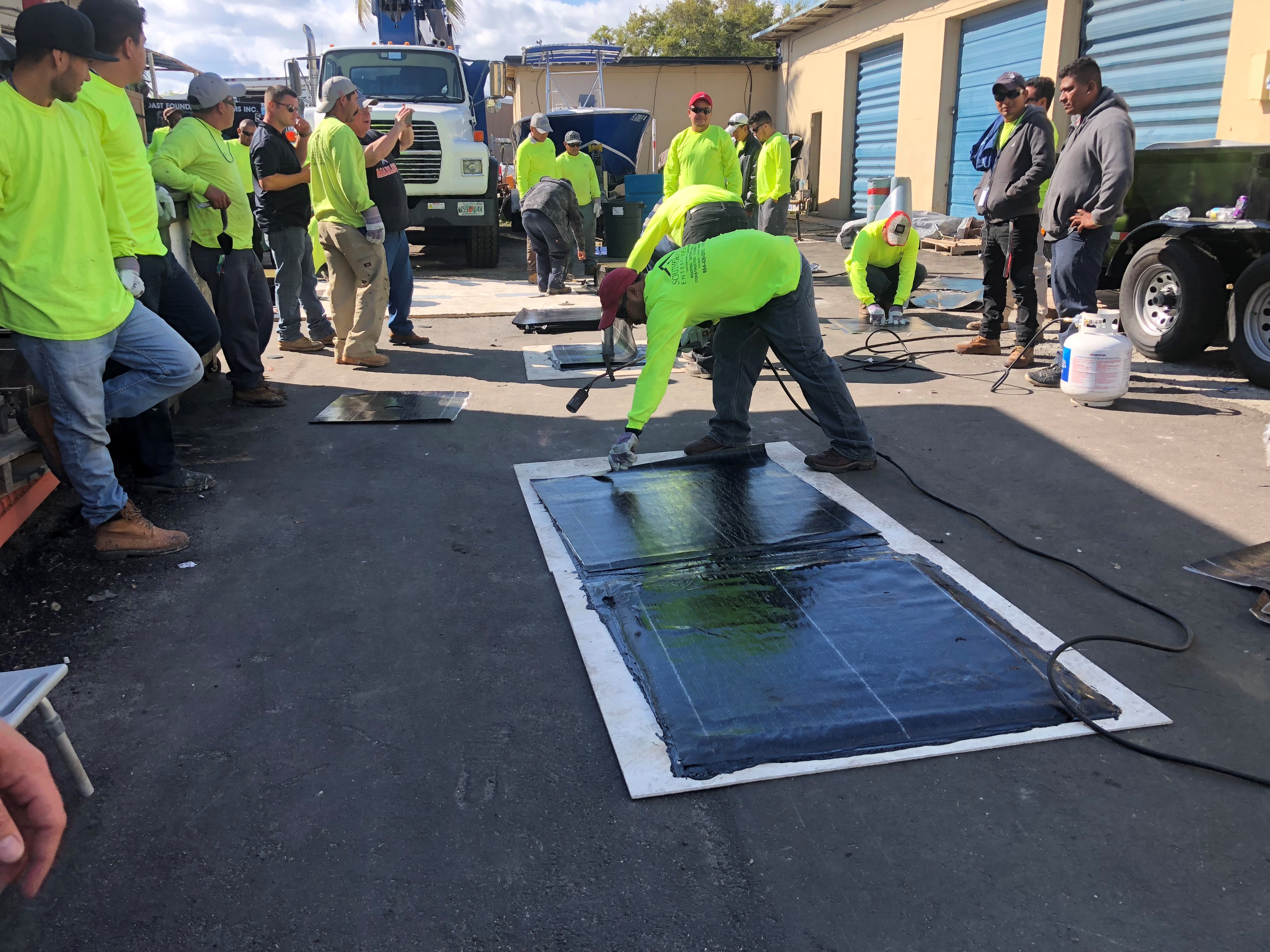 Southern Coast team members practicing a roofing detail during a hands-on training session