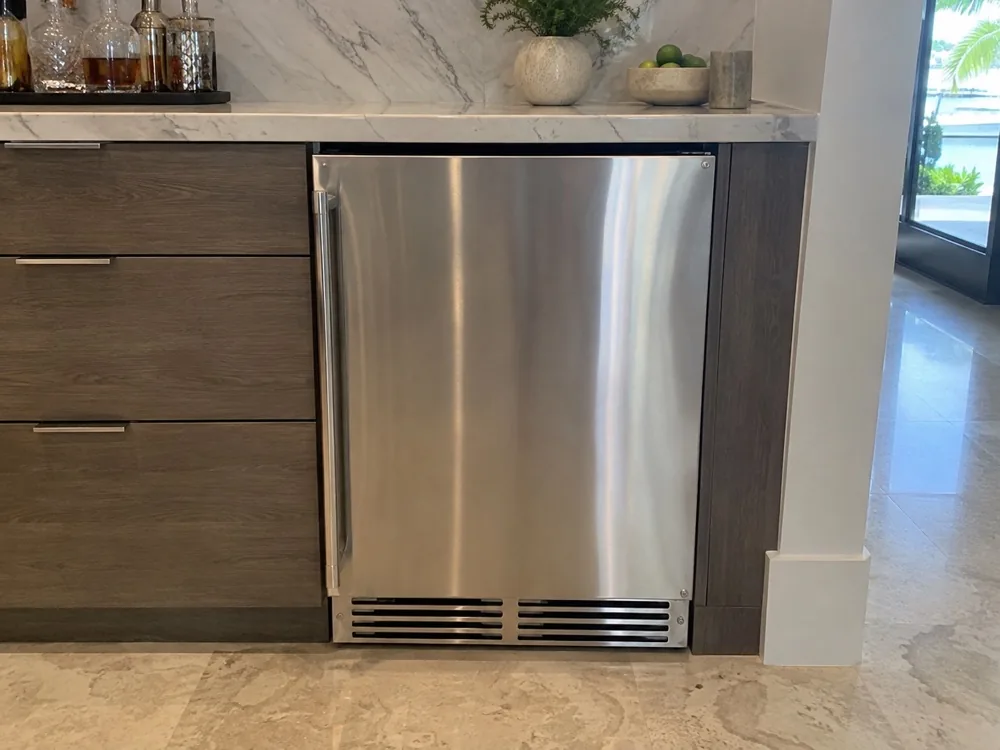 Undercounter ice maker after repair in a Miami home bar area