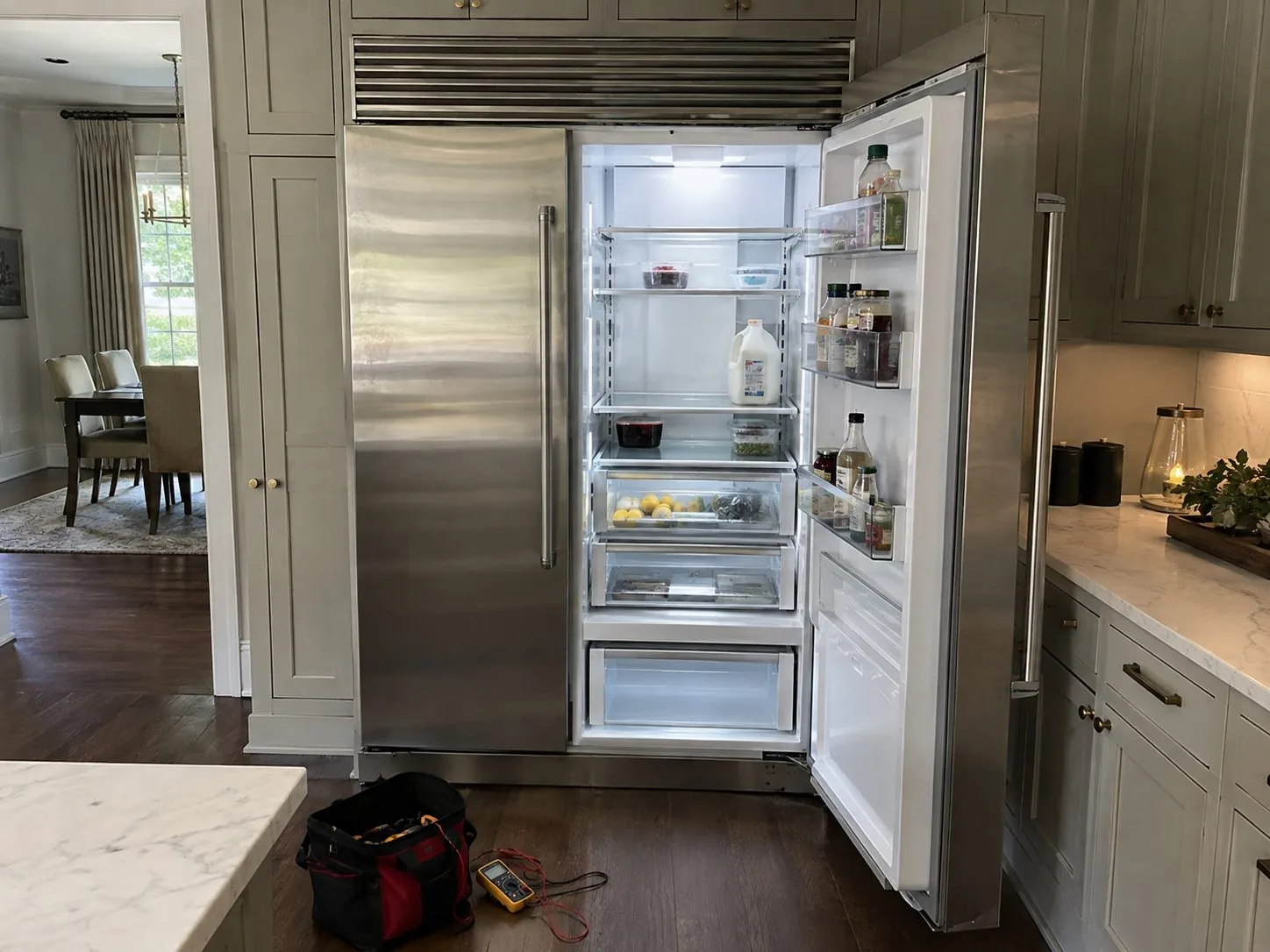 Built-in refrigerator checked after repair in an Atlanta kitchen