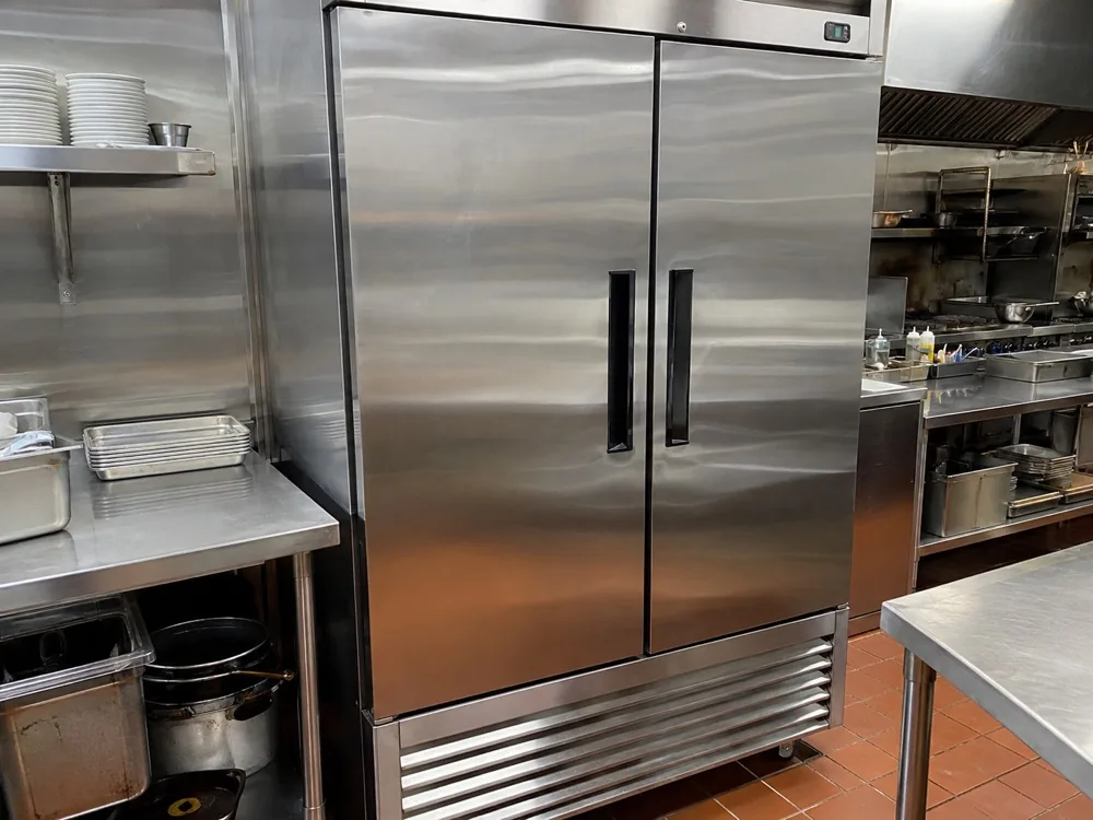 Commercial reach-in refrigerator photographed after service in a Miami restaurant kitchen