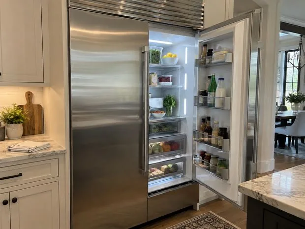 Built-in refrigerator photographed with the door open after diagnostic service