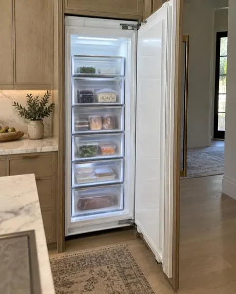 Panel-ready integrated freezer photographed after service in a customer home