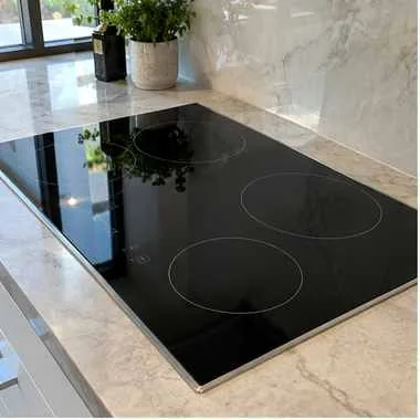 Induction cooktop photographed after service in a customer kitchen