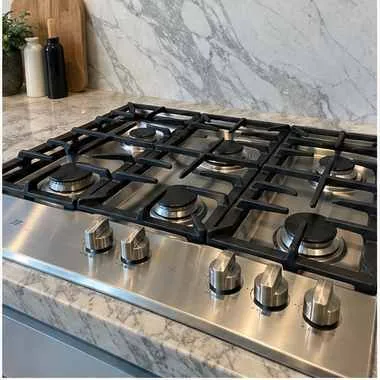 Gas cooktop photographed after repair in a customer kitchen