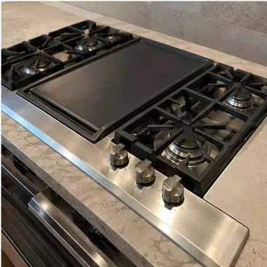Modular cooktop photographed after repair in a customer kitchen