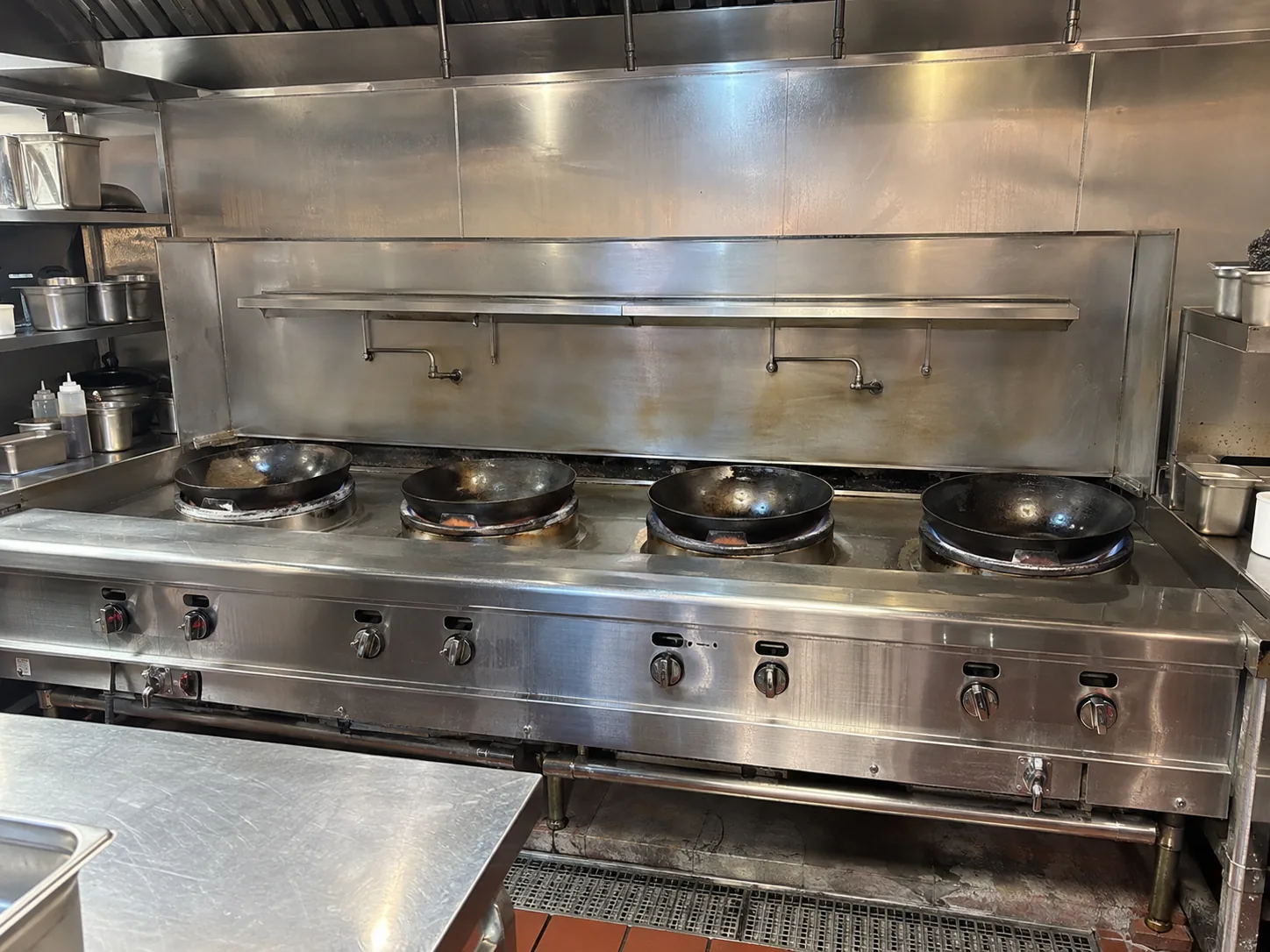 Large commercial wok range line after uneven heat output service in Metro Atlanta