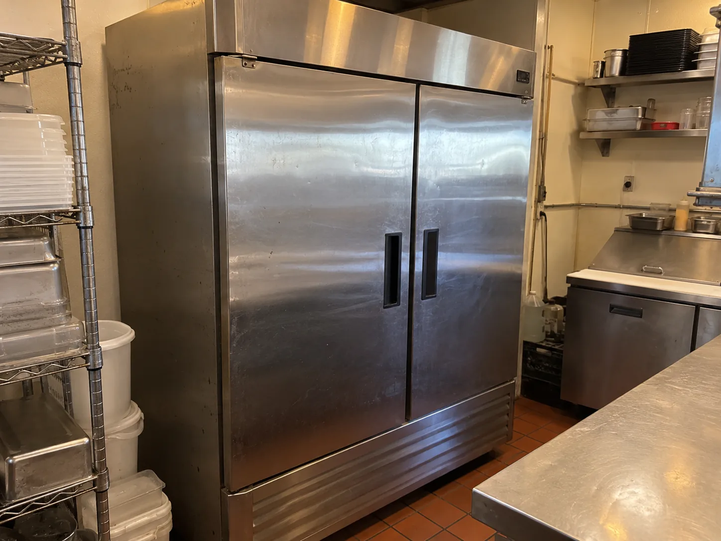 Wide two-door commercial reach-in freezer in a Carrollwood kitchen after door alignment service