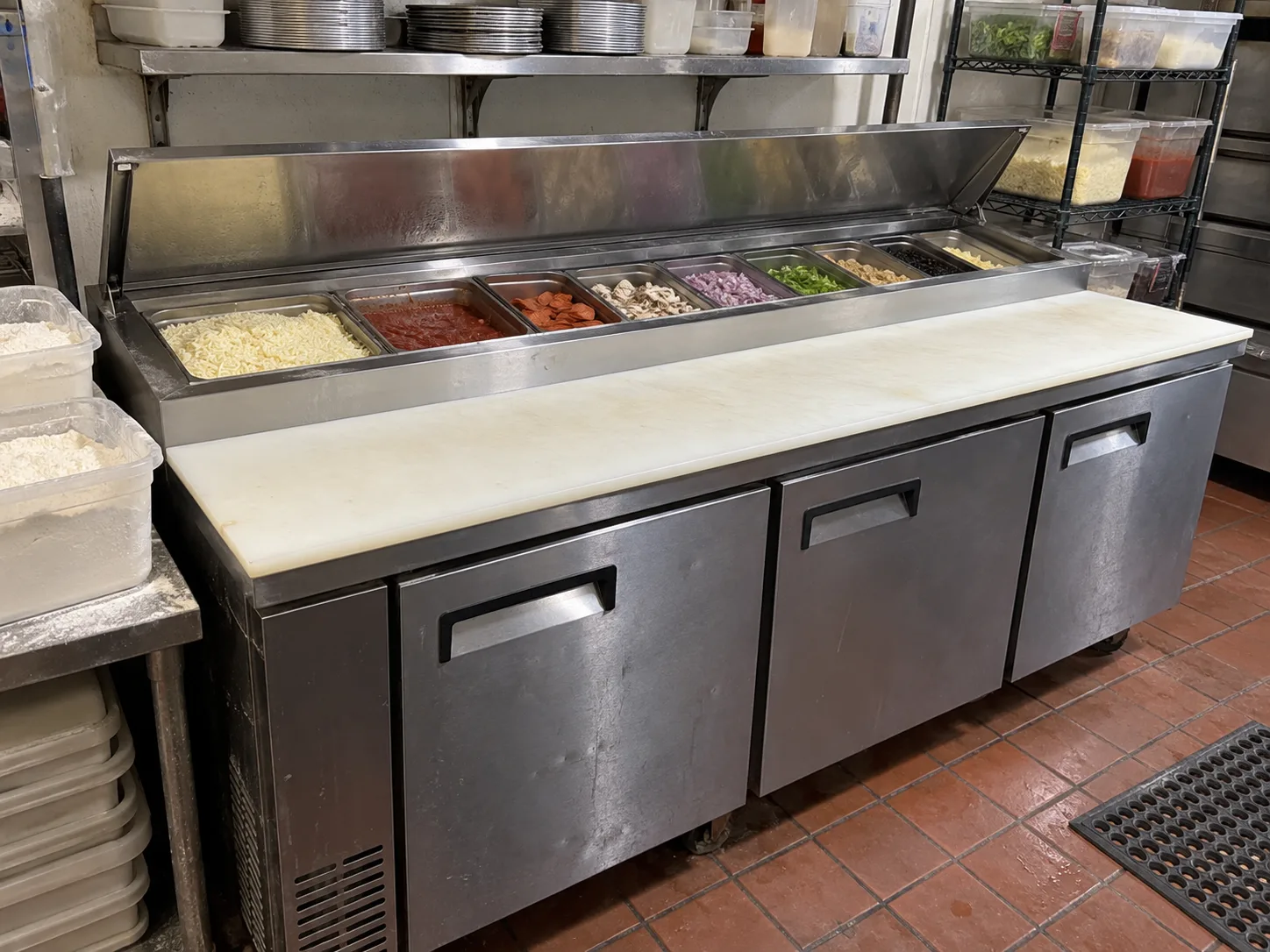 Three-door pizza prep refrigerator after temperature service in Buckhead