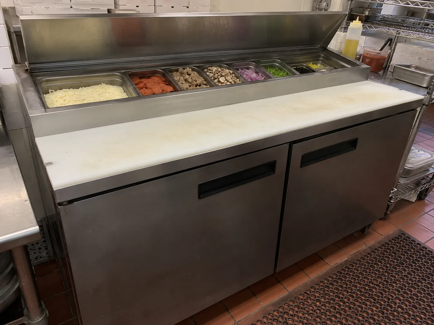 Pizza prep table after ingredient rail cooling service in Downtown Tampa
