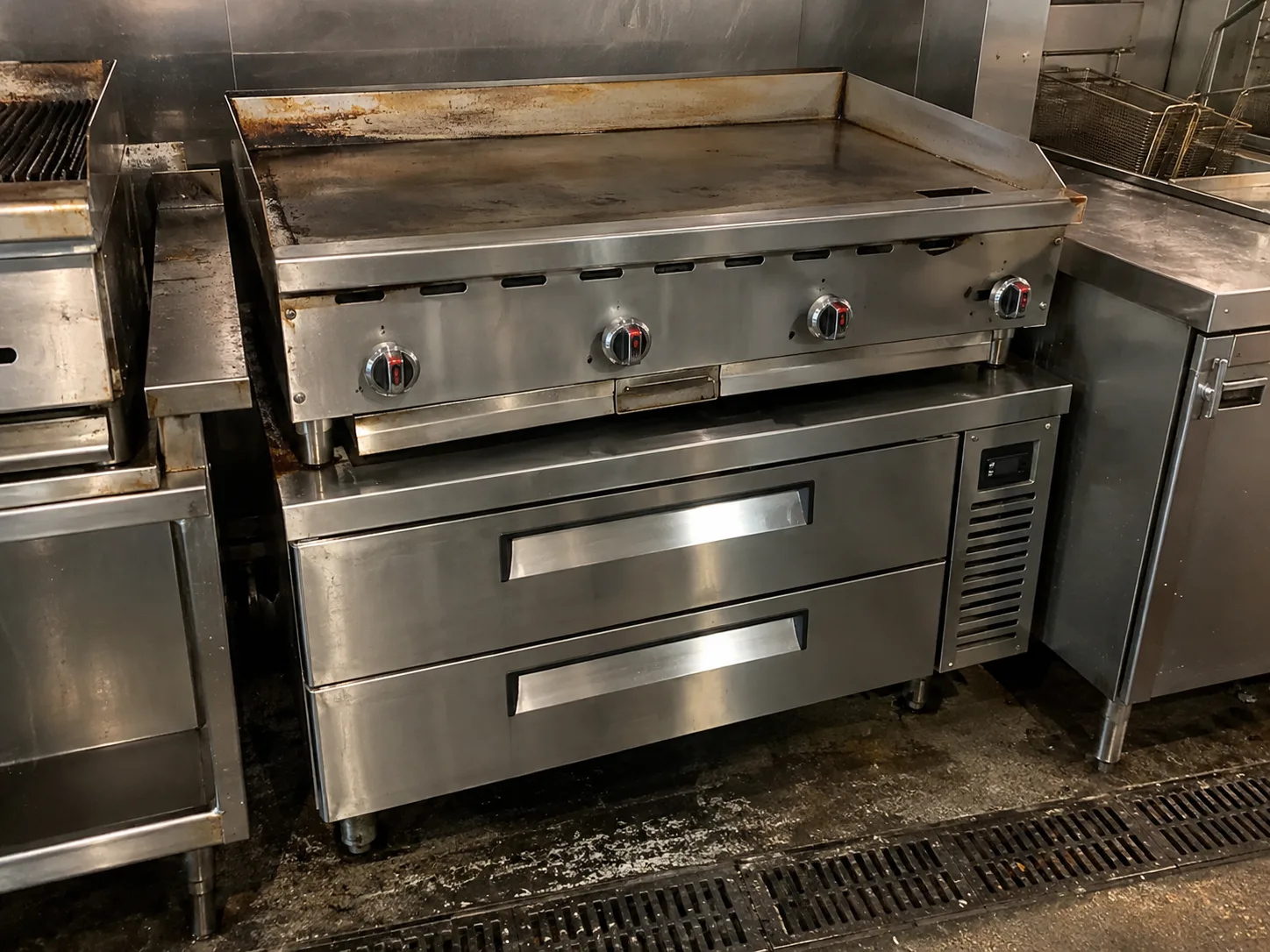 Four-drawer chef base beneath a charbroiler in Ybor City after service