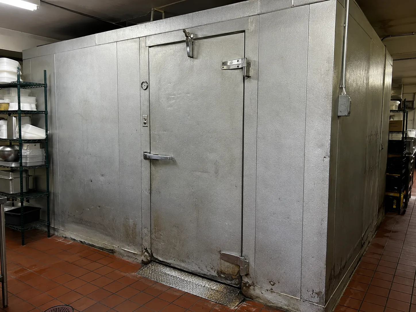 Commercial walk-in cooler door after closure repair