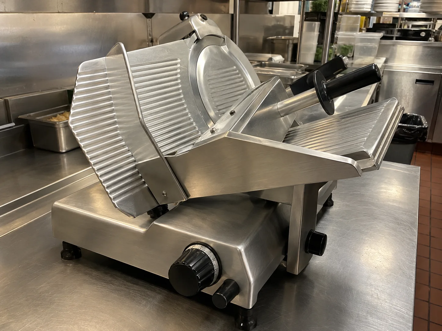Gravity-feed commercial meat slicer after service in South Tampa
