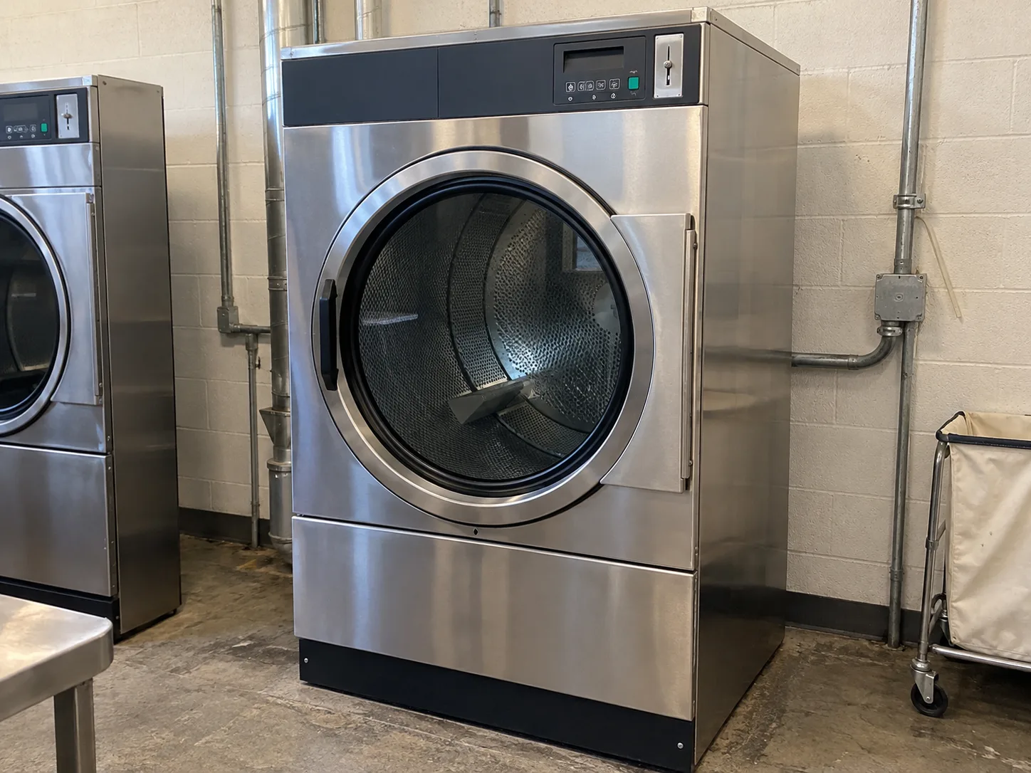 Commercial laundry dryer after temperature control service in a utility room