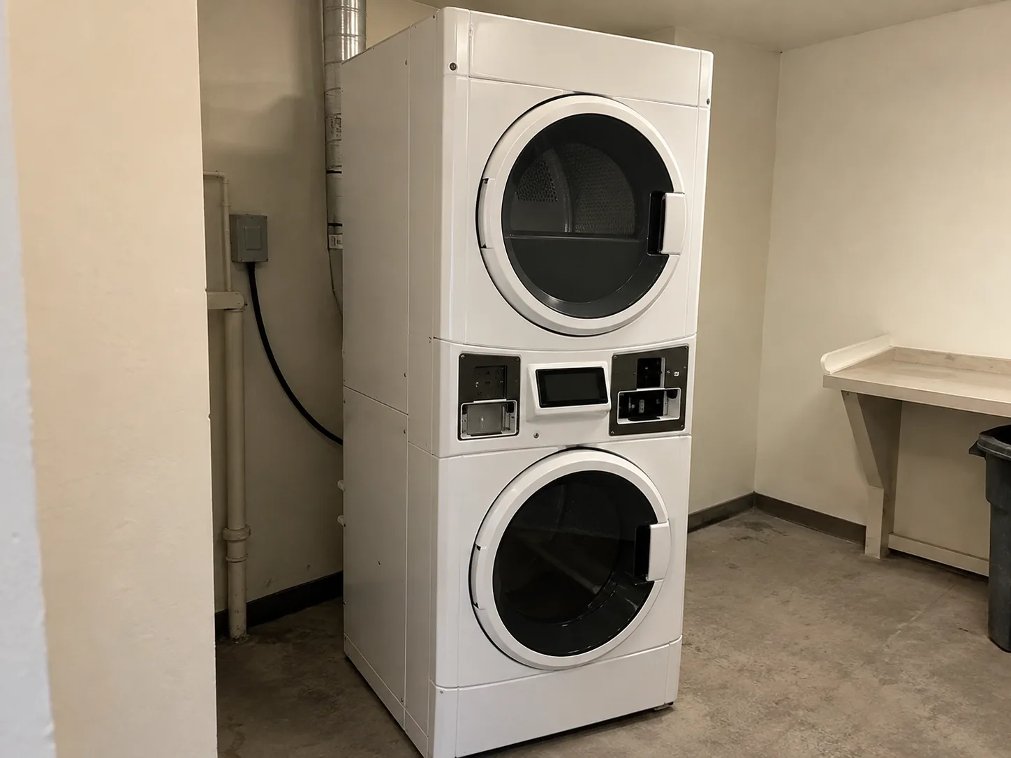 Stack commercial dryer unit after shutdown repair in a multi-housing laundry room