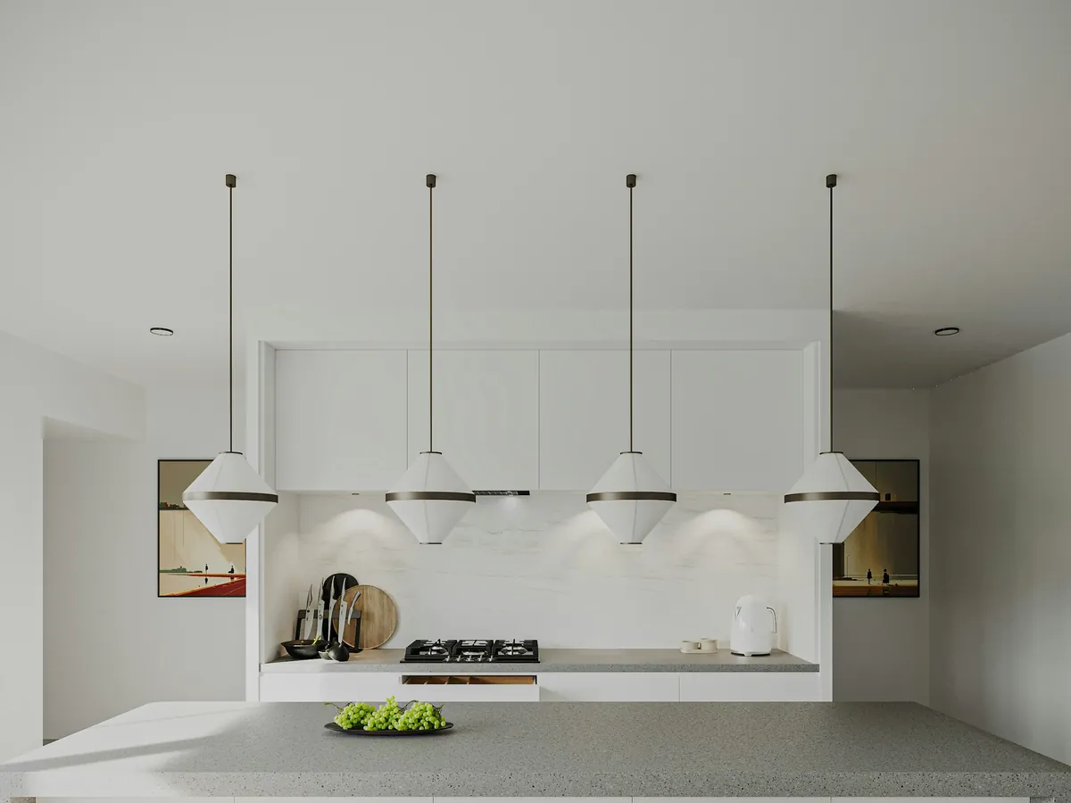 Kitchen island lit by a row of pendant lights