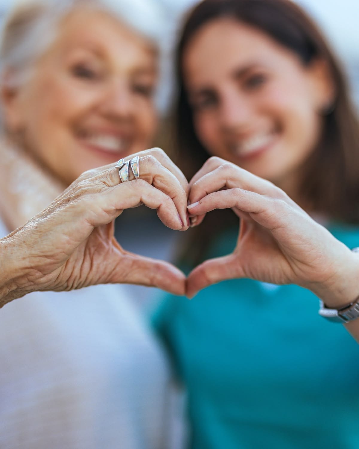 Senior mother and adult daughter laughing together