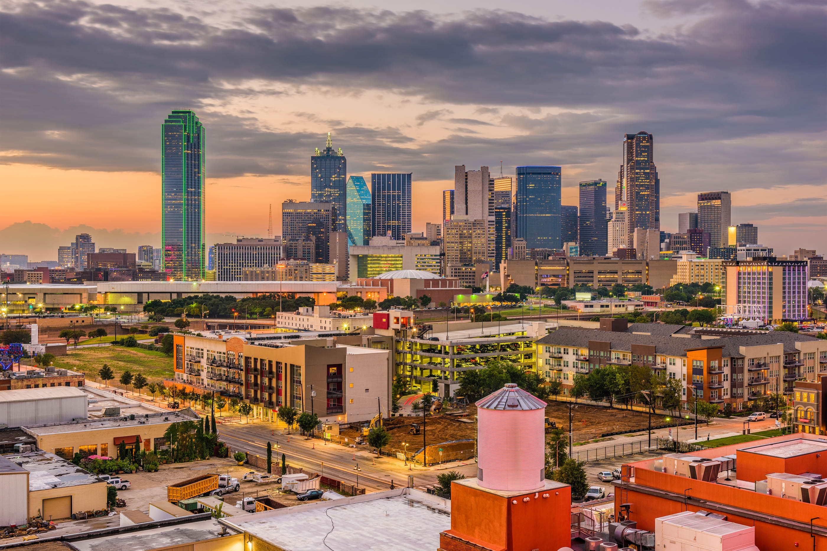 Dallas skyline at dusk with a pink water tank in the foreground