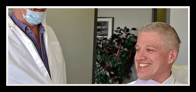 Patient smiling in the dental chair while speaking with the clinician at Southland Denture Clinic