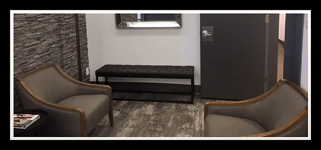 Waiting area with armchairs and a black tufted bench at Southland Denture Clinic