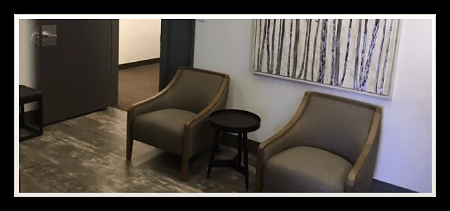 Waiting area with two grey armchairs at Southland Denture Clinic