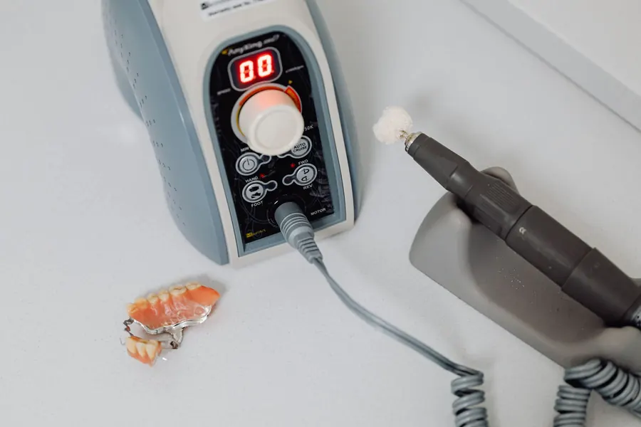 Dental lab polishing unit with a partial denture on the bench (stock photo)