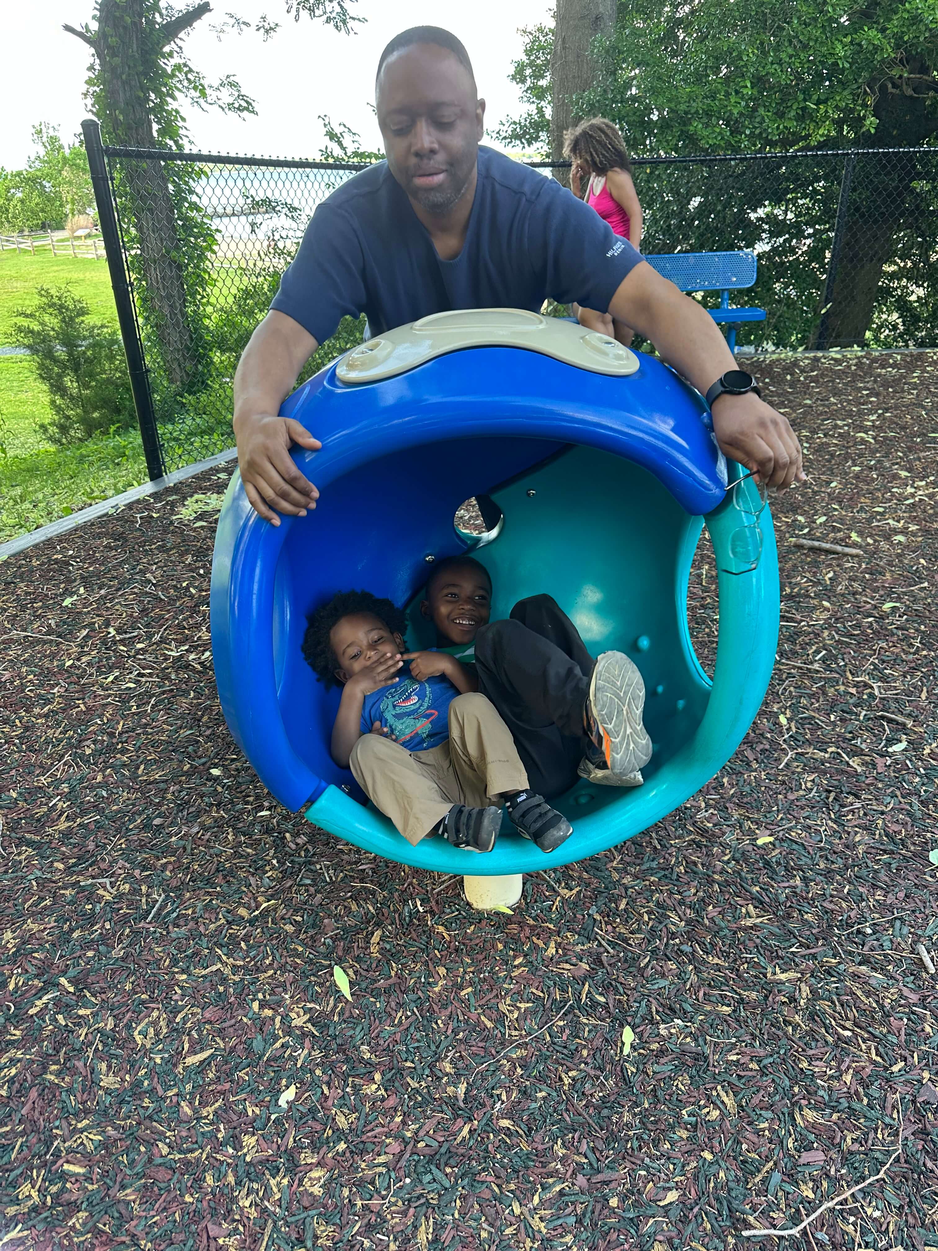 black father and sons at mayo beach playground in maryland black father and sons at mayo beach playground in maryland