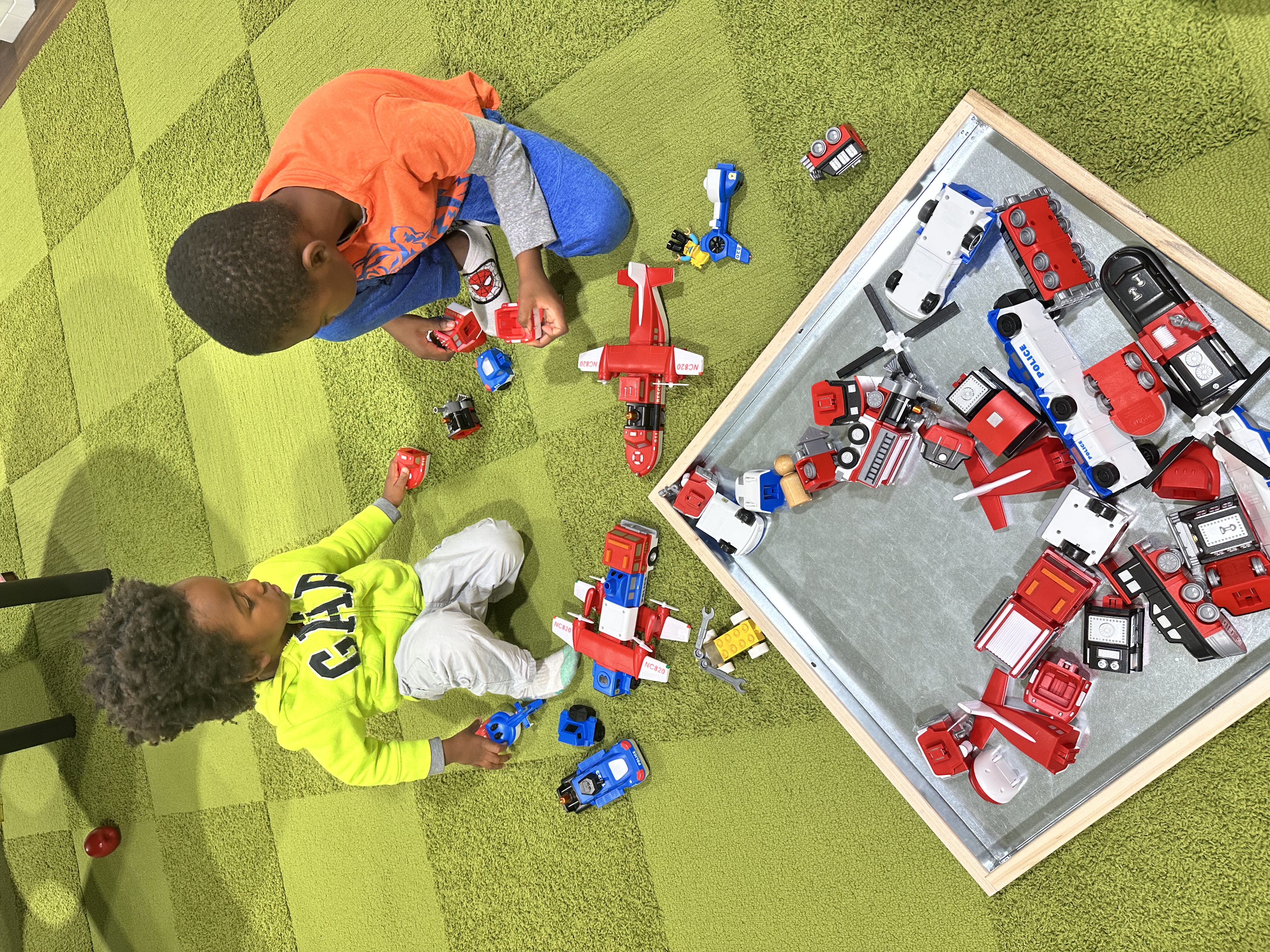 black brothers playing with toy cars