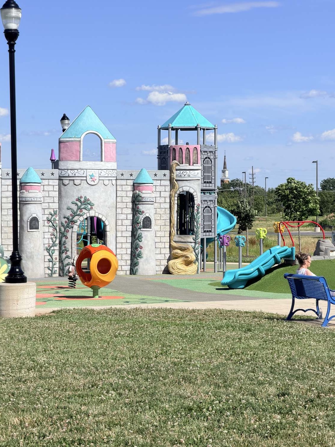 Fairytale castle play structure with turquoise turrets and a blue slide at Sophie and Madigan's Playground in Frederick, Maryland Fairytale castle play structure with turquoise turrets and a blue slide at Sophie and Madigan's Playground in Frederick, Maryland