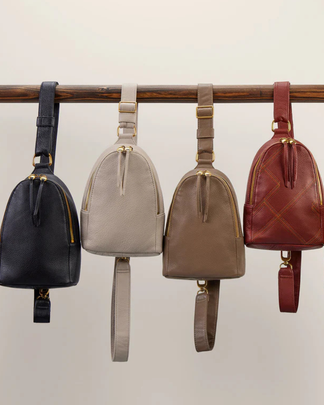 Leather sling bags in black, cream, taupe and burgundy