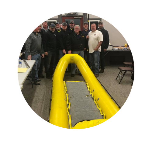 image of osfc board donating a boat to the oshkosh fire dept.