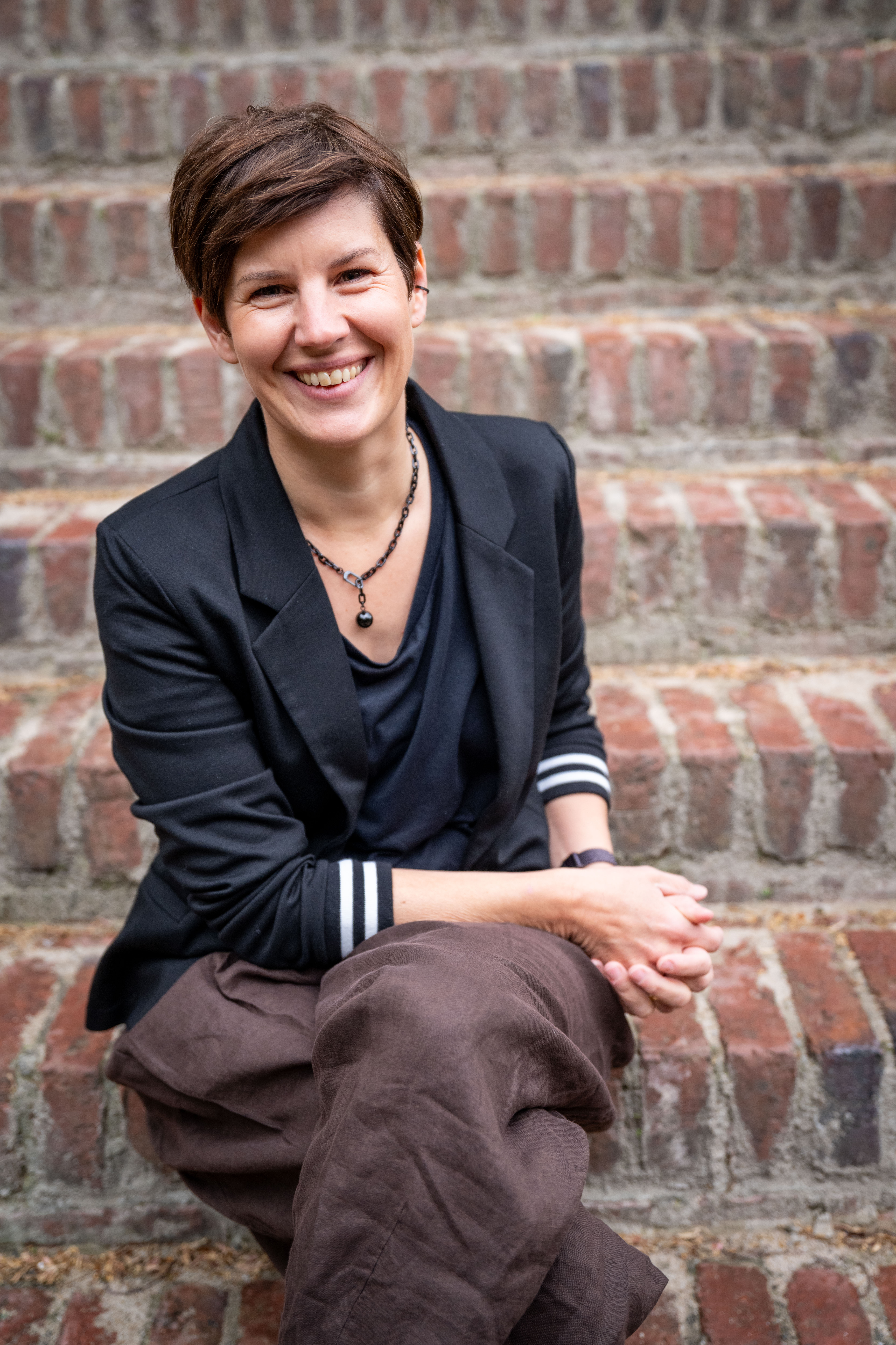Portrait of the founder in an editorial style, three-quarter view, soft studio light, neutral background