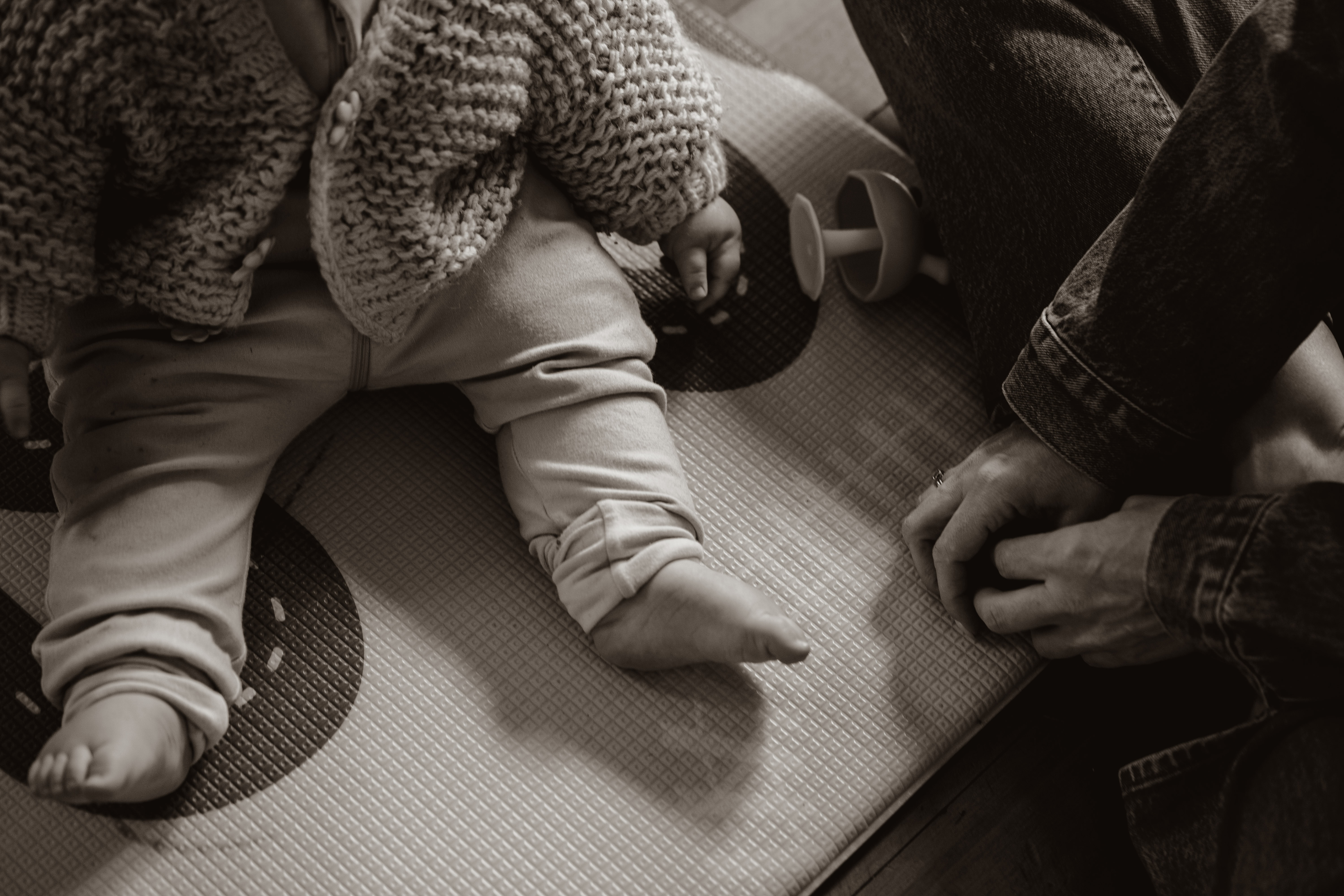 Baby feet on floorboards