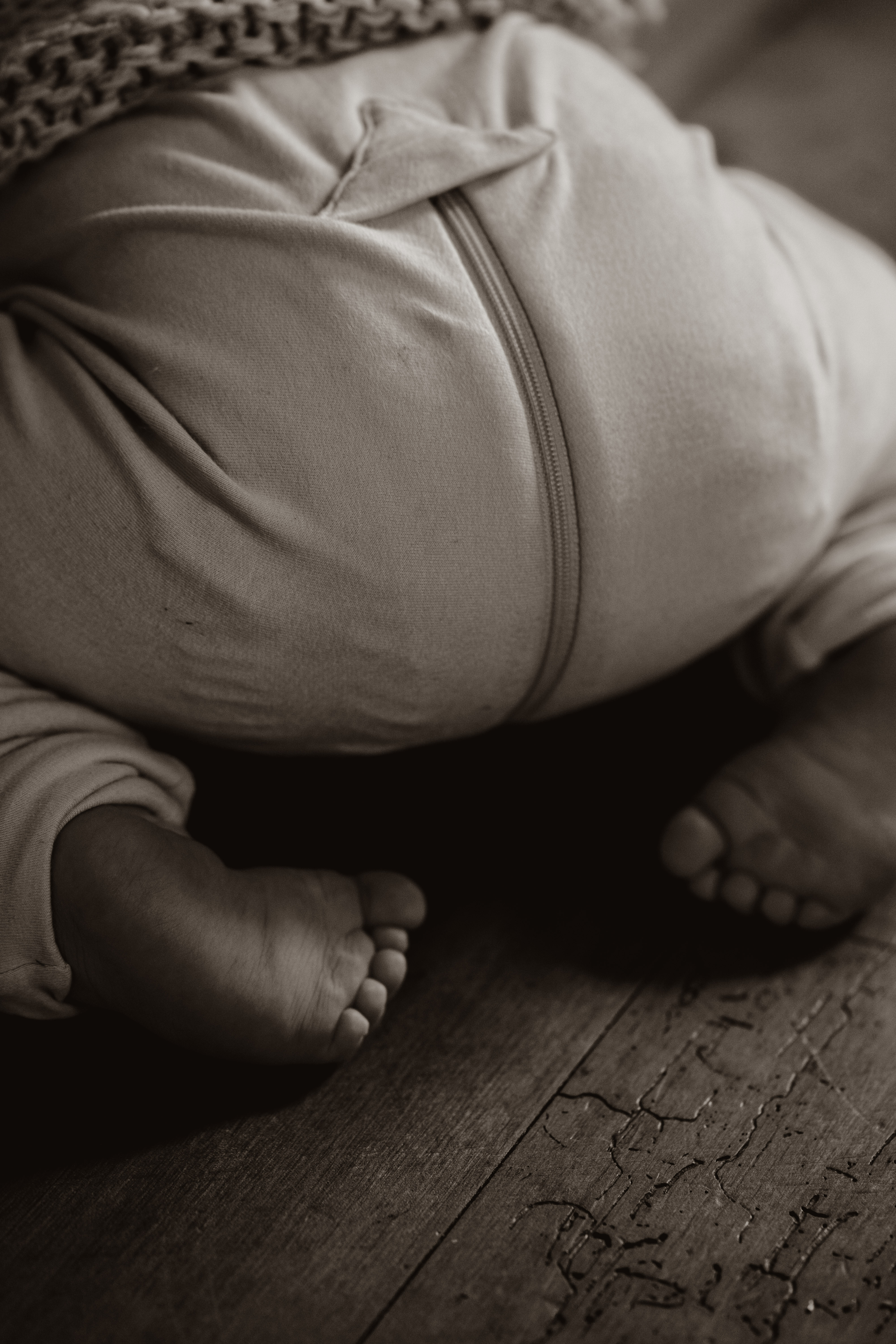 Baby feet on floorboards